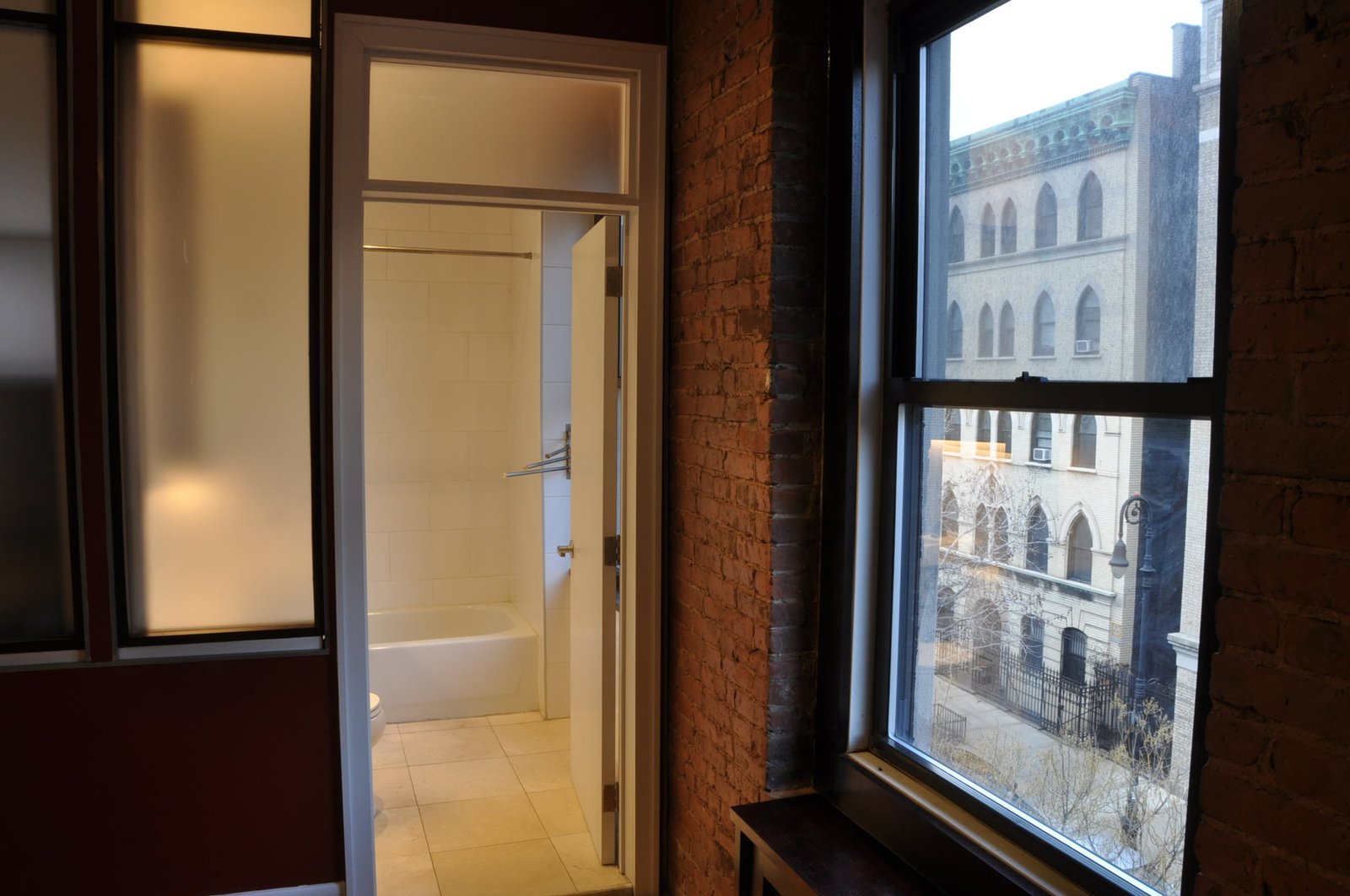 Bathroom doorway with adjacent window view to opposite Gothic facade