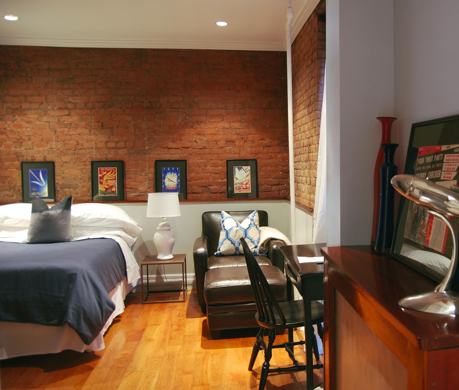 Unit 1C main room with exposed brick