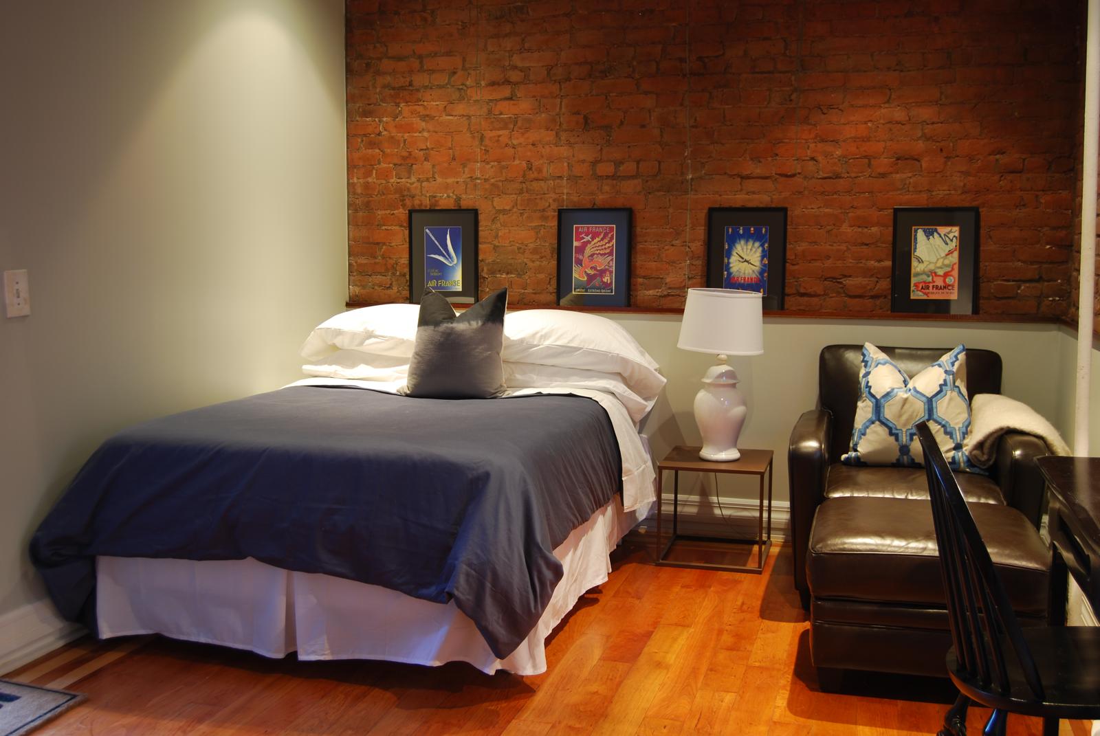 Main room with brick wall