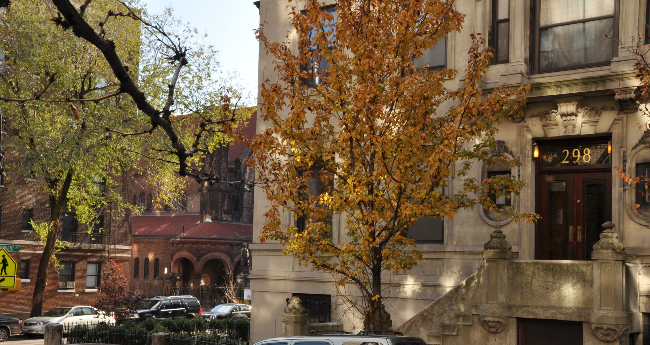 The limestone entrance of 298 Convent Avenue in autumn
